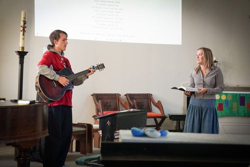 Young Female and Male Student Leading Worship