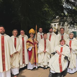 Bishop Mary with the nine newly ordained priests