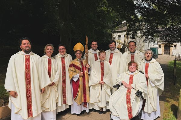 Bishop Mary with the nine newly ordained priests