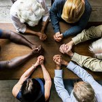 Six people in prayer