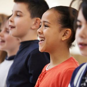 A group of primary aged children singing