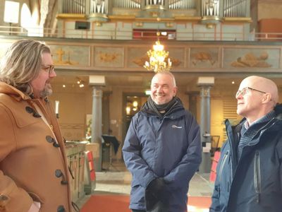 Three men in a church in Sweden
