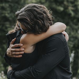 Funeral mourners embrace