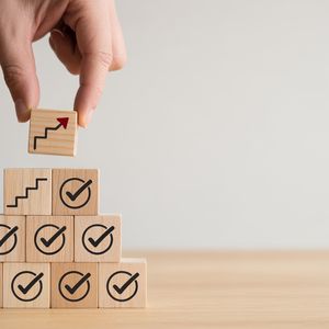 Series of boxes with check marks, representing achievement of aims and organisational targets