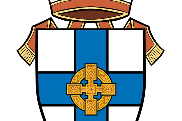 A crest with a shield-like design with a blue cross over it, gold cross in centre, topped with a white, mitre with red and gold edging