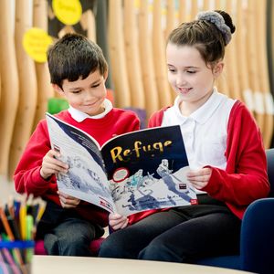 Children reading the book Refuge