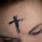 A cross drawn on a forehead in ash