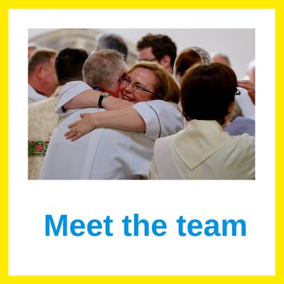 Priest hugging a colleague